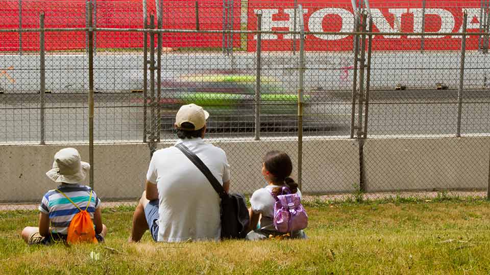 A Father and his kids watching the races at the Honda Indy Toronto