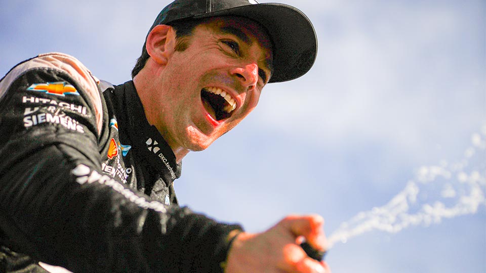 Simon Pagenaud celebrates with Champagne after his win at the Honda Indy Toronto